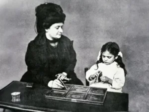 Dr. Maria Montessori demonstrating child-centered teaching methods at the first Casa dei Bambini in Rome, Italy, circa 1907